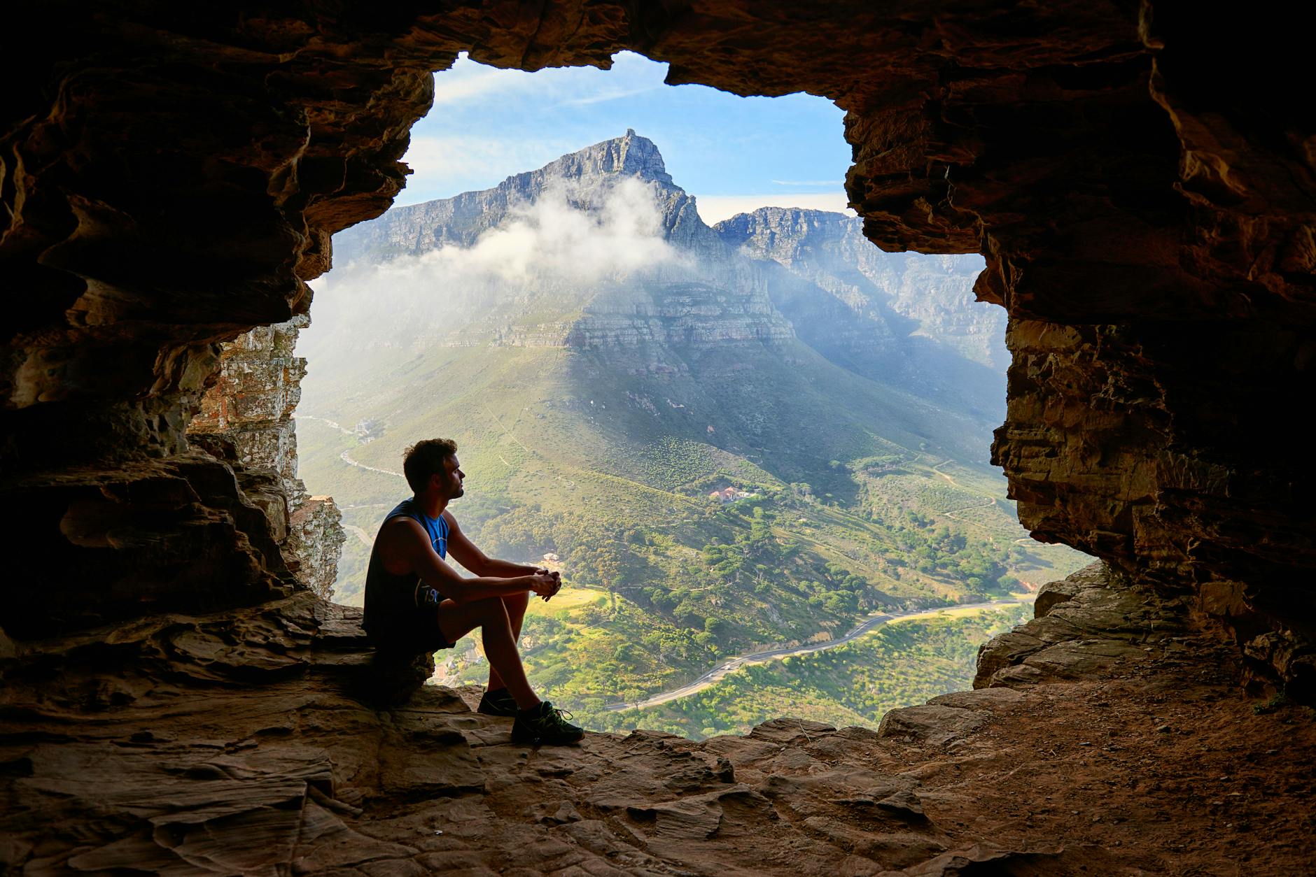 photo of man sitting on a cave refelcting on trauma counseling