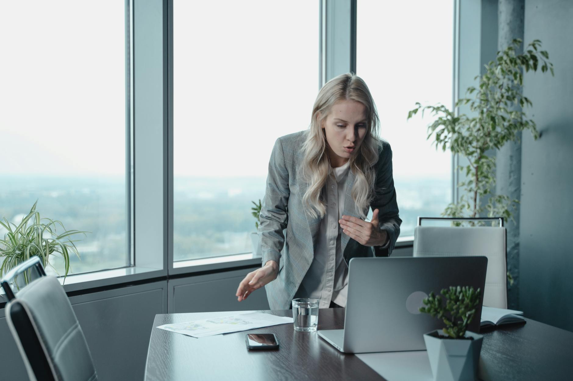 woman in gray blazer having a video conferencing