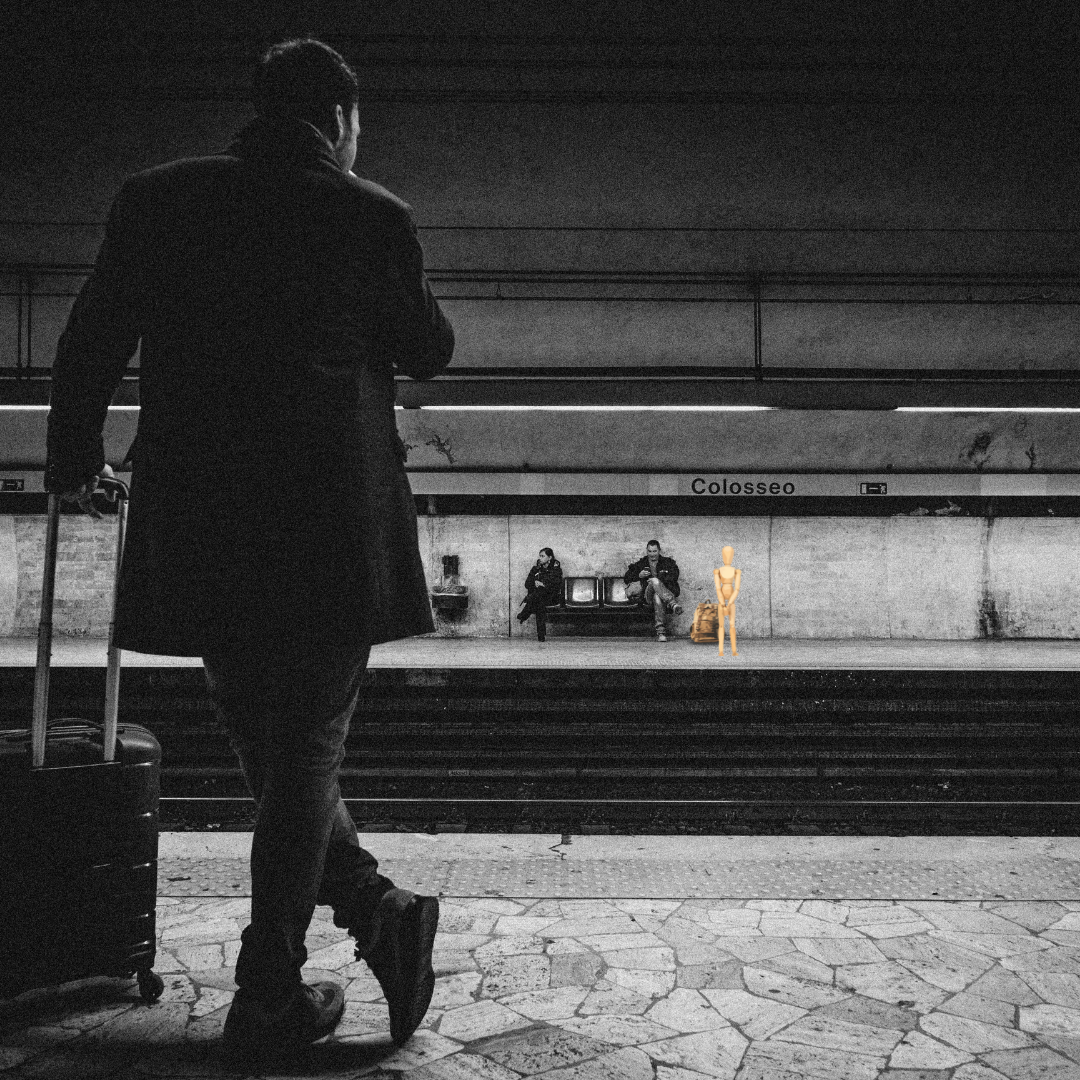 person traveling in a subway station with a suitcase