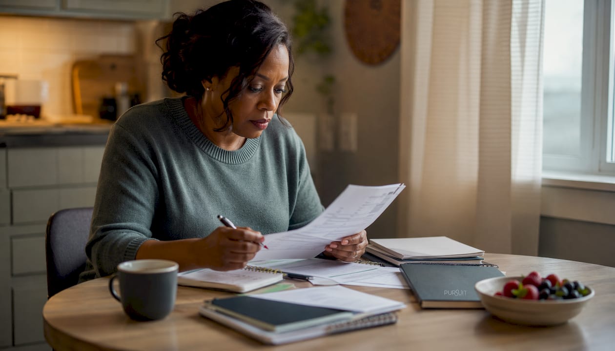 Woman reviewing insurance paperwork at home office