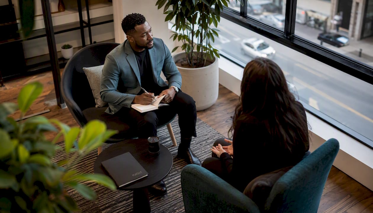 Executive receiving coaching in bright office